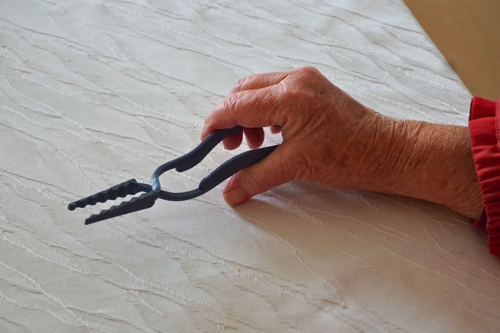 Eine Hand hält das Lomega ergonomische Besteck